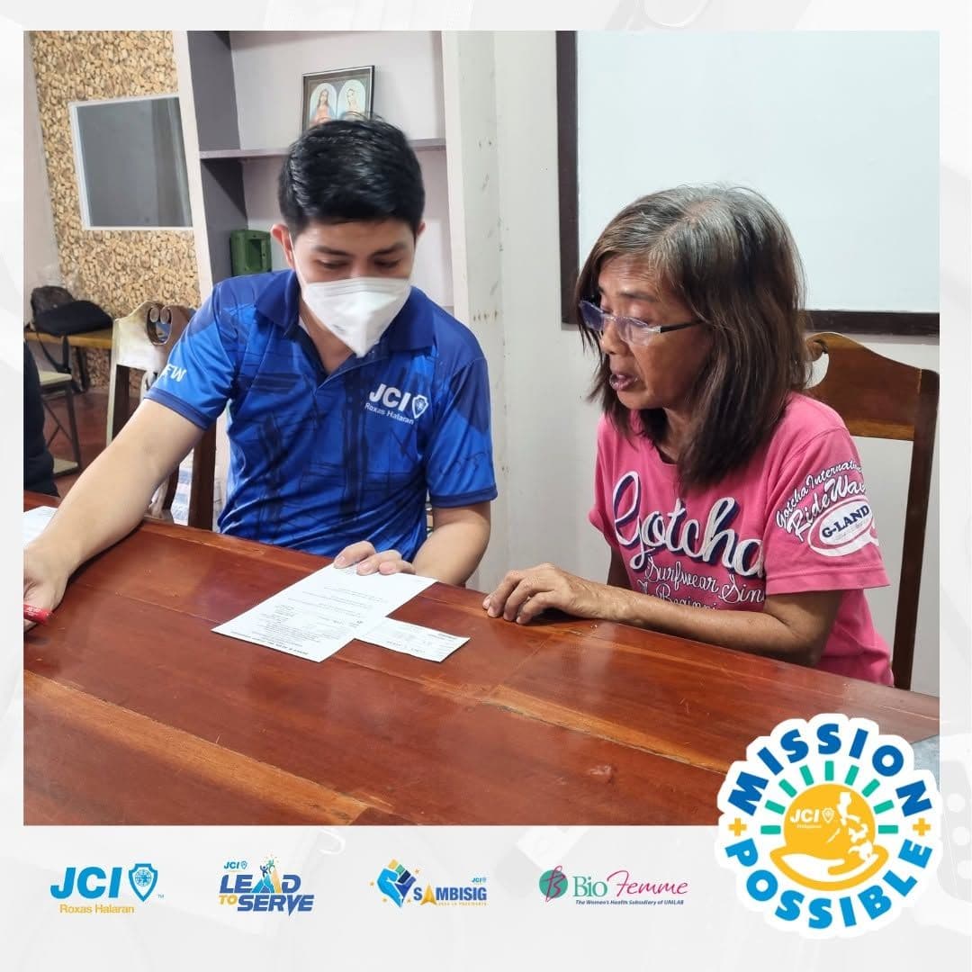 A health worker doing a free anemia screening at a desk