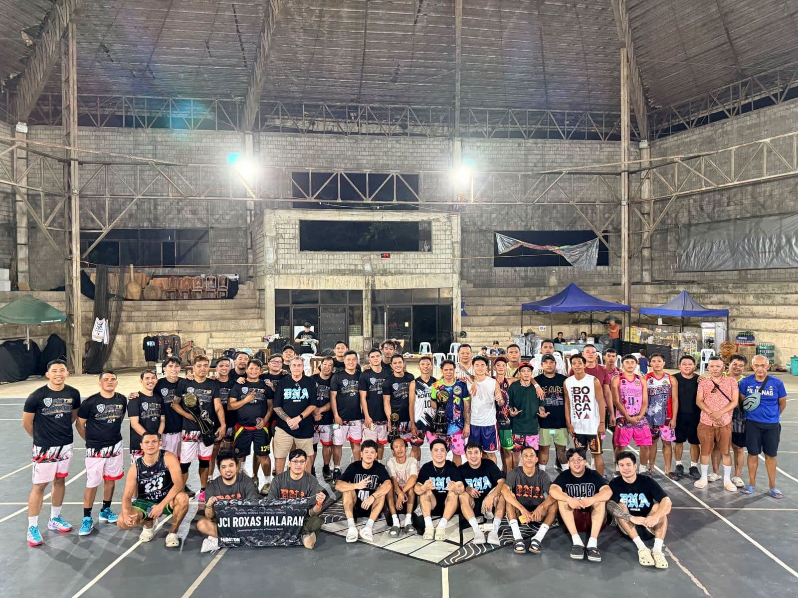 Teams and organizers of the IPBC T10 Invitational Basketball League on an indoor court